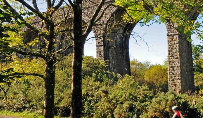 Photo of cyclists on a trail under a viaduct on the Granite Way