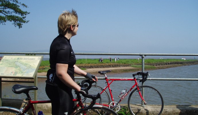 Photo of a cyclist looking out over the Exe Estuary at Turf Locks