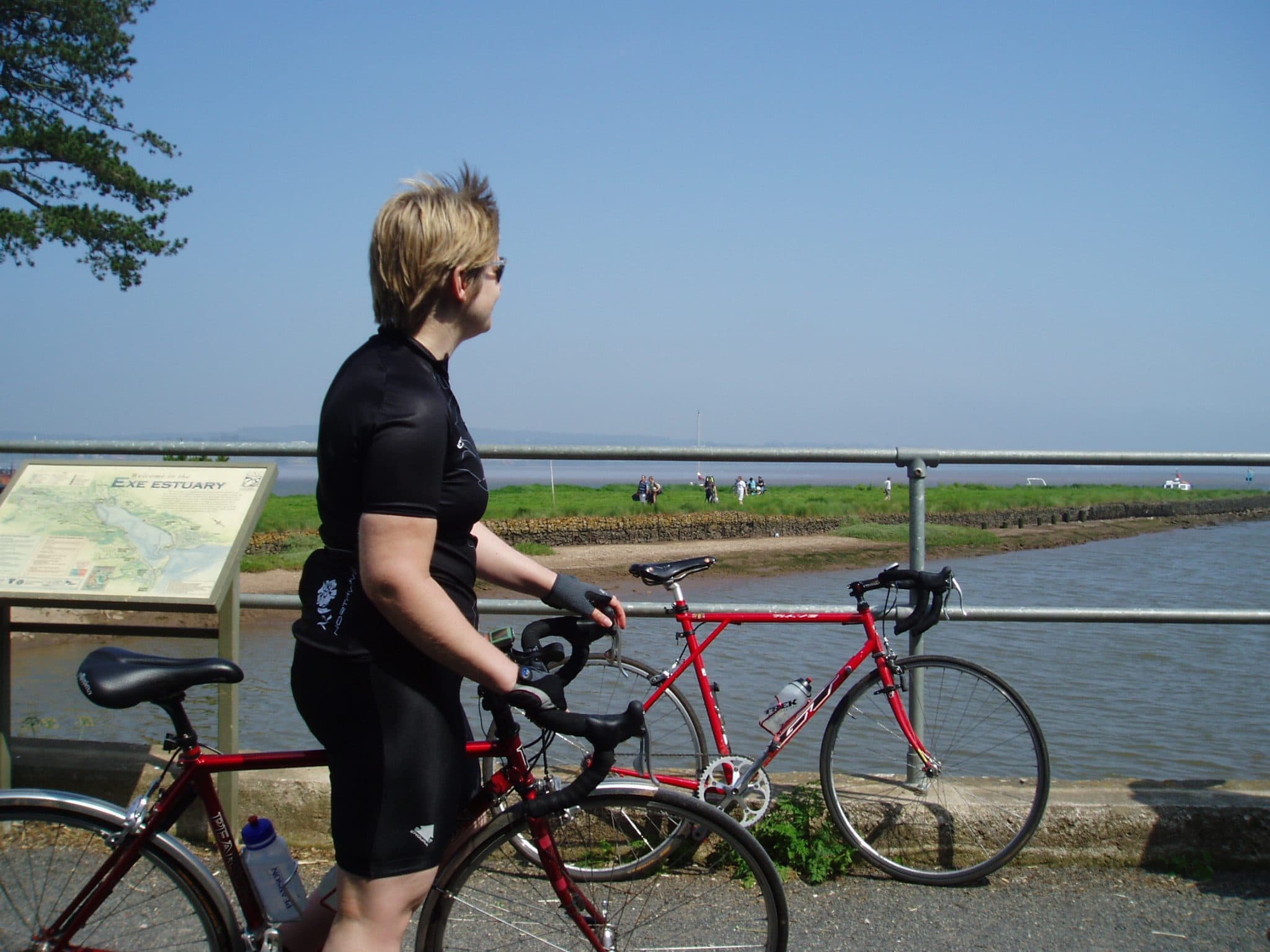 Photo of a cyclist looking out over the Exe Estuary at Turf Locks