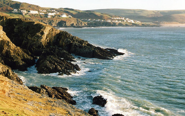 Photo looking along the coast past rocky cliffs to Mortehoe and Woolacombe from Morte Point