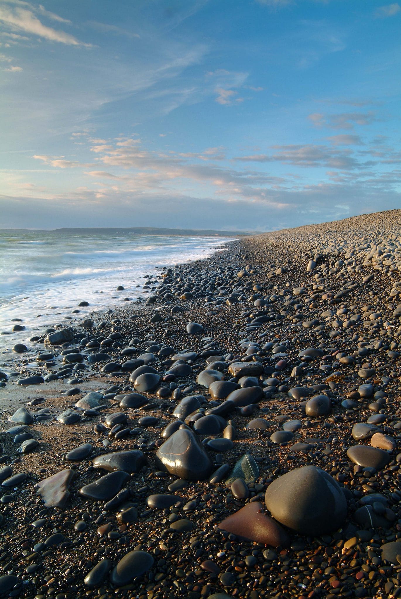 Photo of the shoreline on a pebble beach