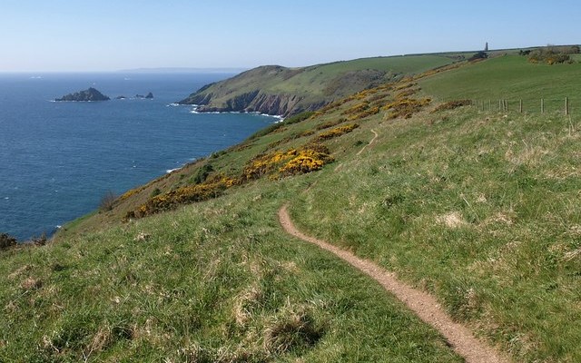 Photo along the South Devon coast showing fields, coastal cliffs and sea with the Daymark in the distance