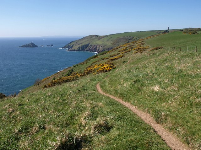 Photo along the South Devon coast showing fields, coastal cliffs and sea with the Daymark in the distance