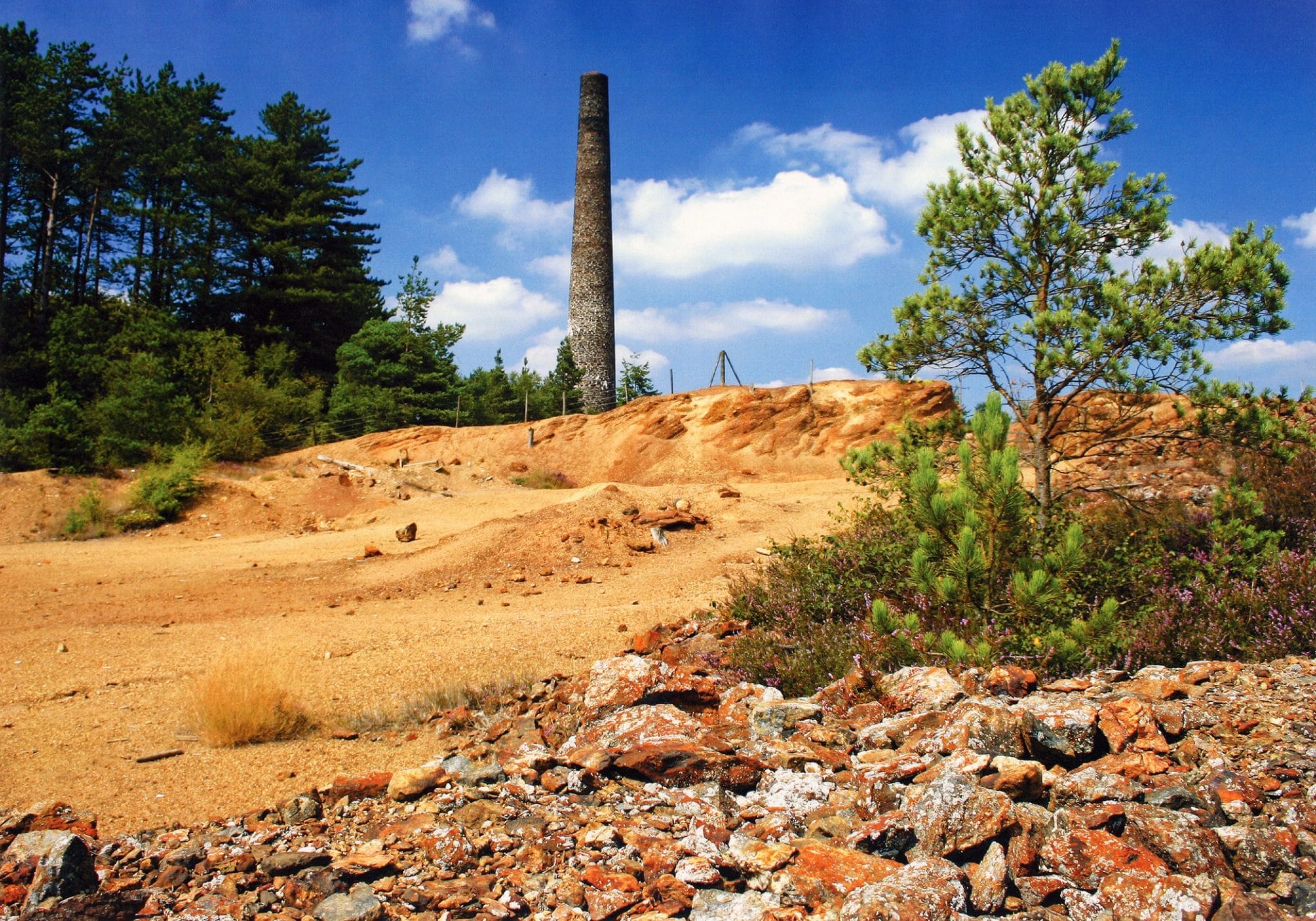 Photo of an arsenic mine tower with waste ground in front