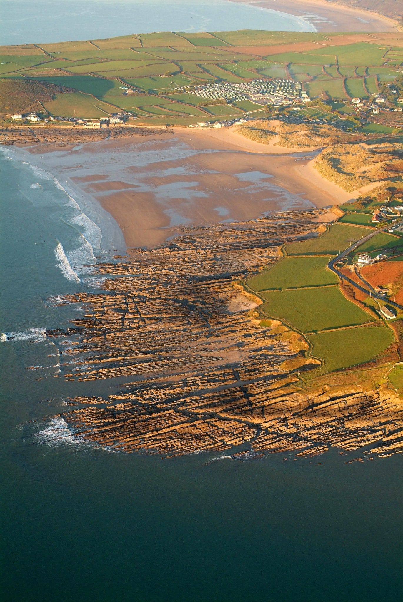 Aerial photo looking down on the beach and rocky shore at Downend and Croyde