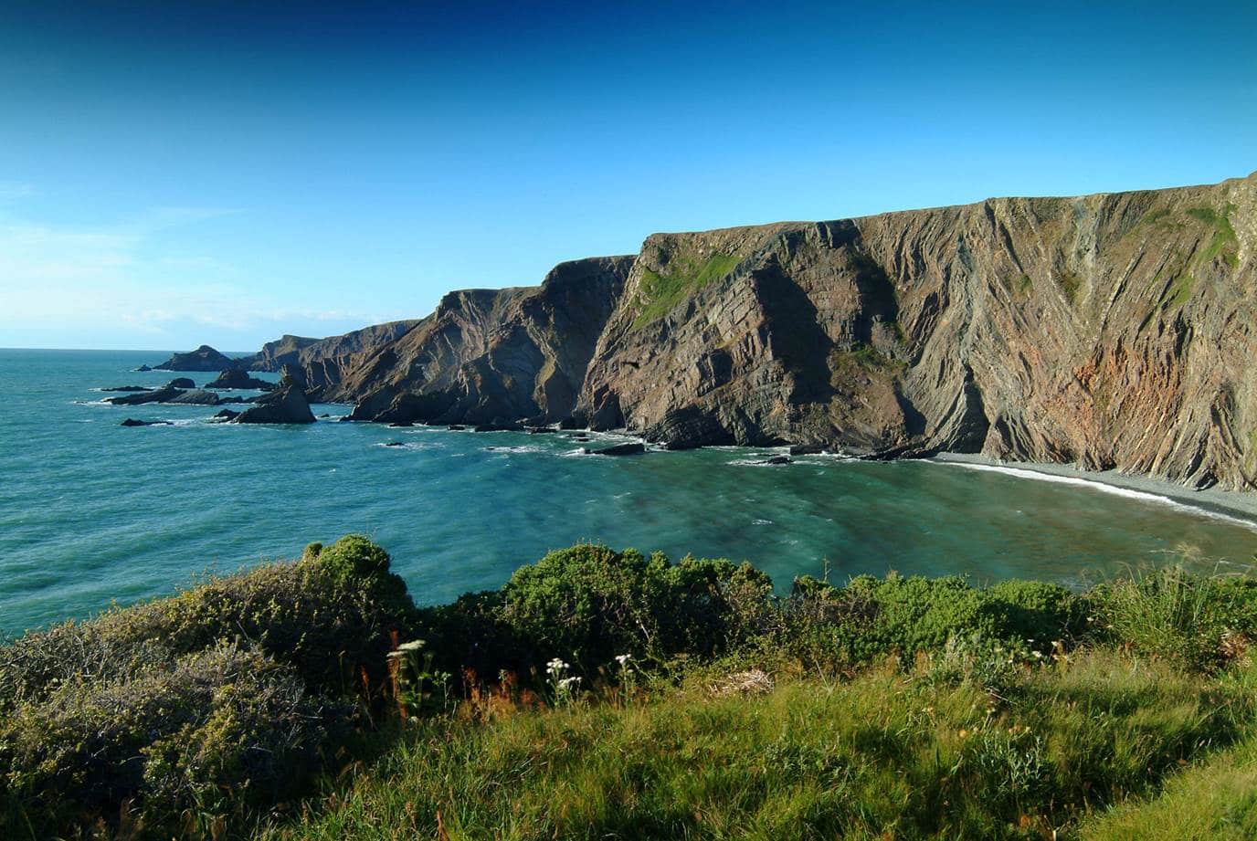 Photo of the Hartland Peninsula showing coastal cliffs and sea