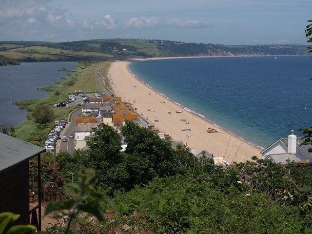 Landscape photo looking along the length of the beach and road at Slapton Ley with lagoon on the left and sea on the right