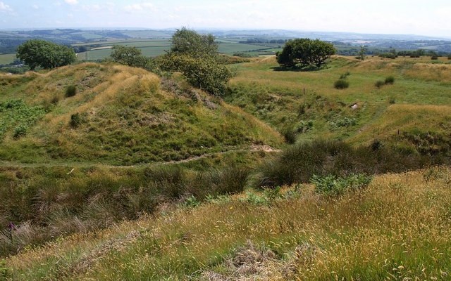 Landscape photos looking across grassy mounds of the iron age hillfort Blackdown Rings