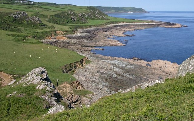 Landscape photo of Prawle Point showing coastal fields and rocky shore