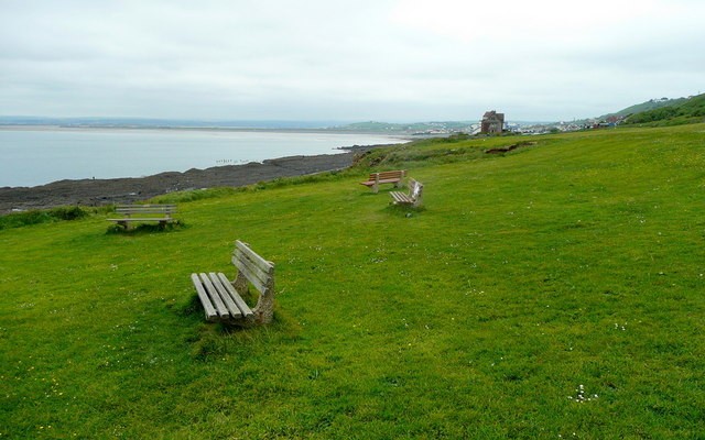 Photo of benches in a green field above the beach at Westward Ho!