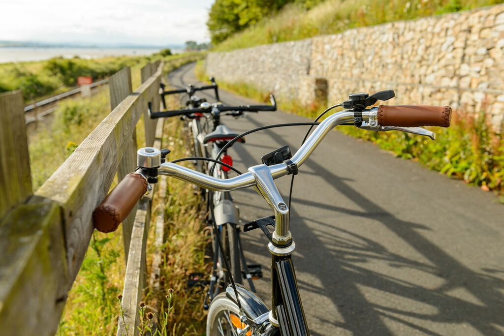 Photo of a line of bicycles standing against a fence on the Exe Estuary Trail