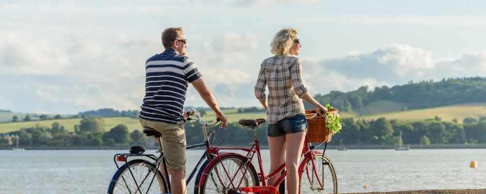 Photo of cyclists on the Tarka Trail alongside the estuary near Instow