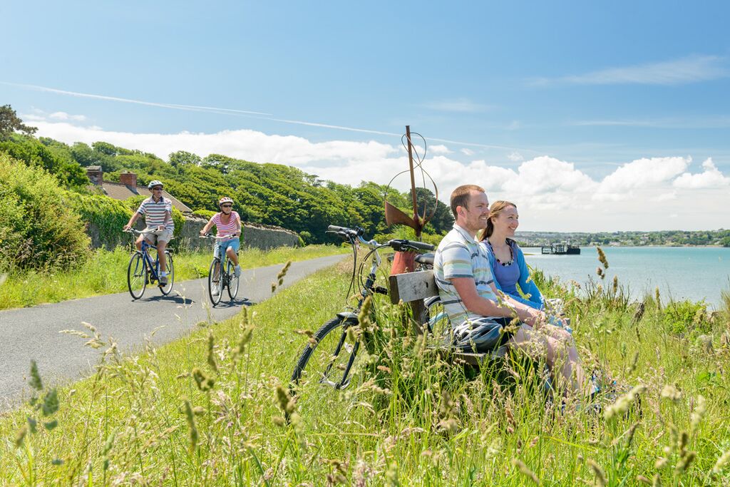 Photo of cyclists on the Tarka Trail alongside the estuary at Instow