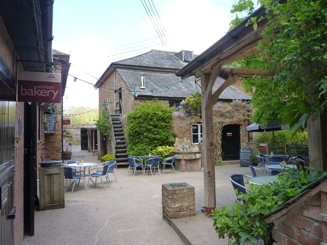 Photo of a courtyard between old mill buildings at Otterton Mill