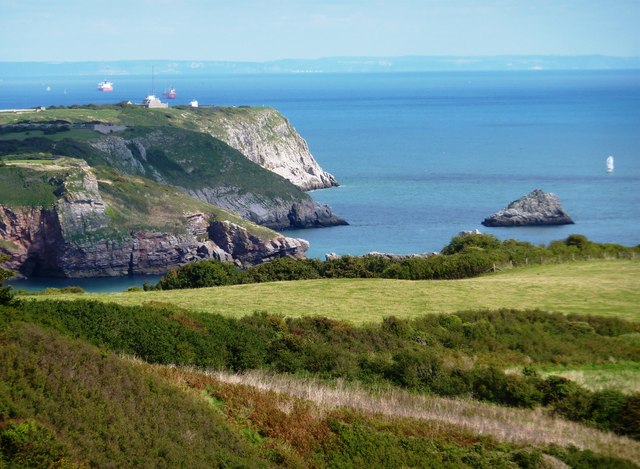 Photo of coastal cliffs at Brixham, with the South Devon coastline in the distance