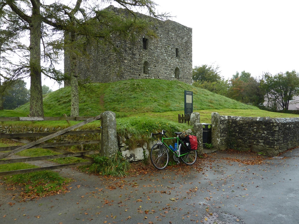 Photo of a bicycle by the gate in front of Lydford Castle