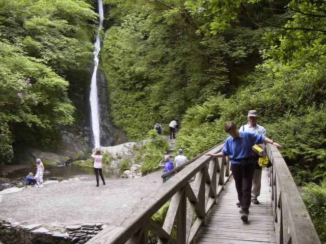 Photo of a bridge and waterfall at White Lady Waterfall in Lydford Gorge