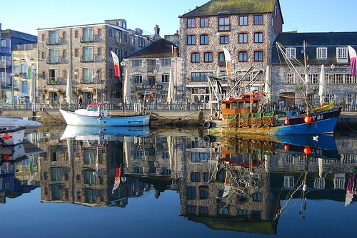 Photo of boats in a marina in front of buildings at Plymouth Barbican